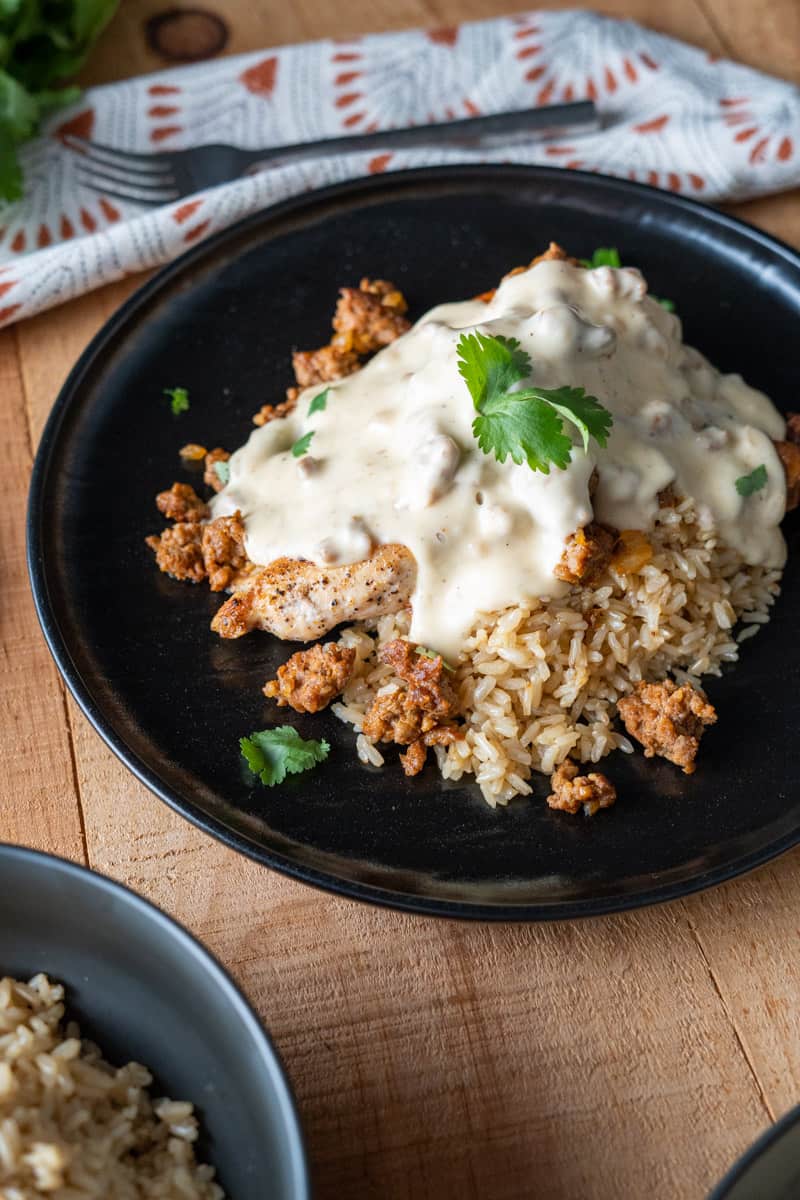 Chori Pollo served over rice garnished with cilantro