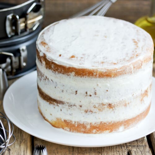 Even layer cake with springform cake pans behind it