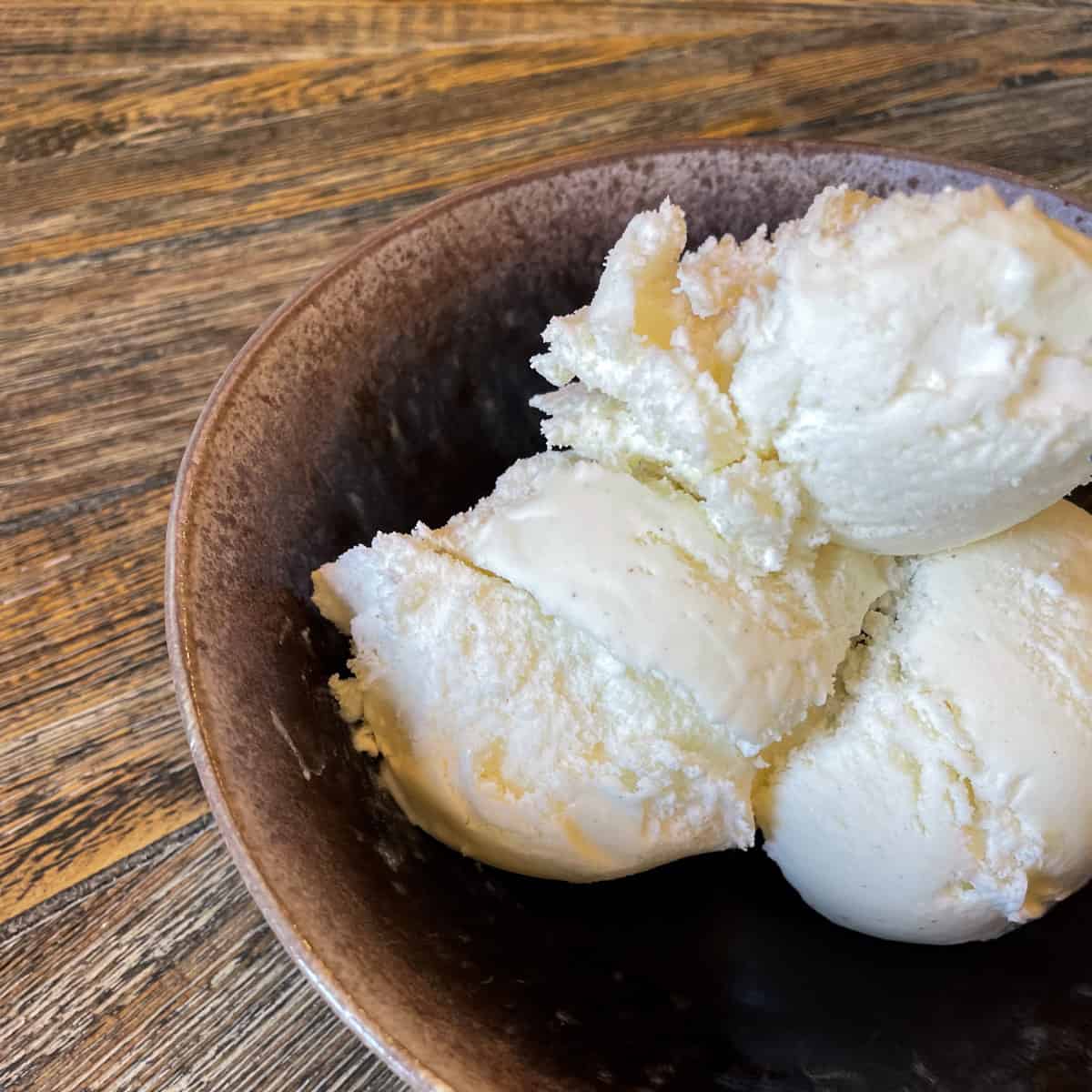 Three scoops of Vanilla bean ice cream in a bowl