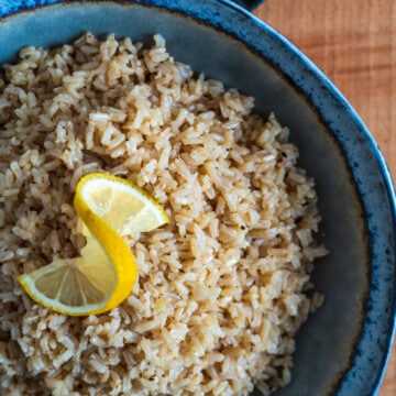 large bowl of garlic butter rice with a slice of lemon on top