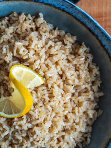 large bowl of garlic butter rice with a slice of lemon on top