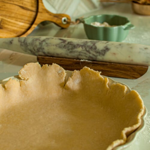 Unbaked pie crust in a dish ready for blind baking