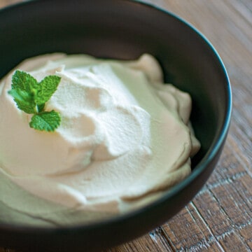 Bowl of homemade whipped cream with fresh mint