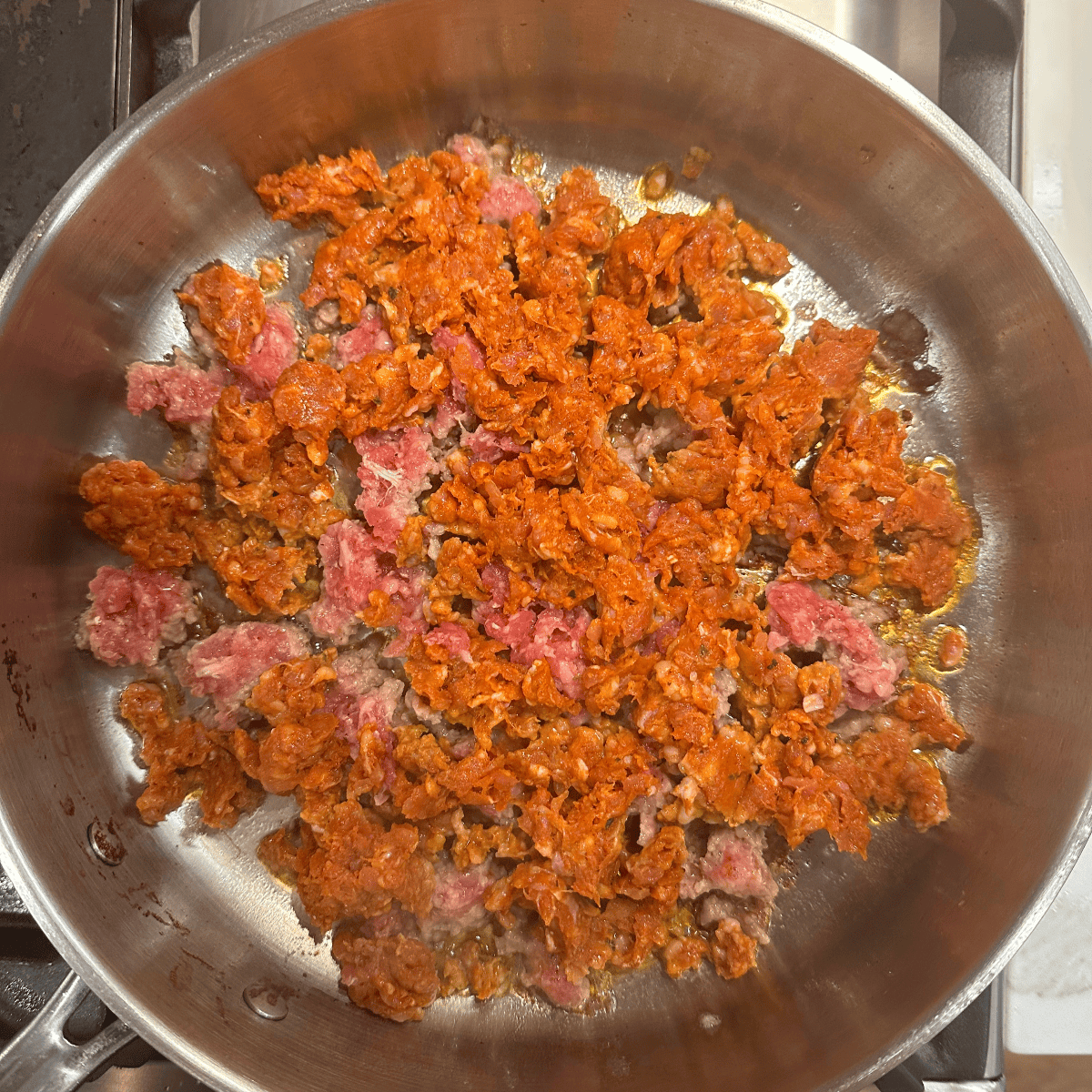 browning chorizo and sausage in a pan