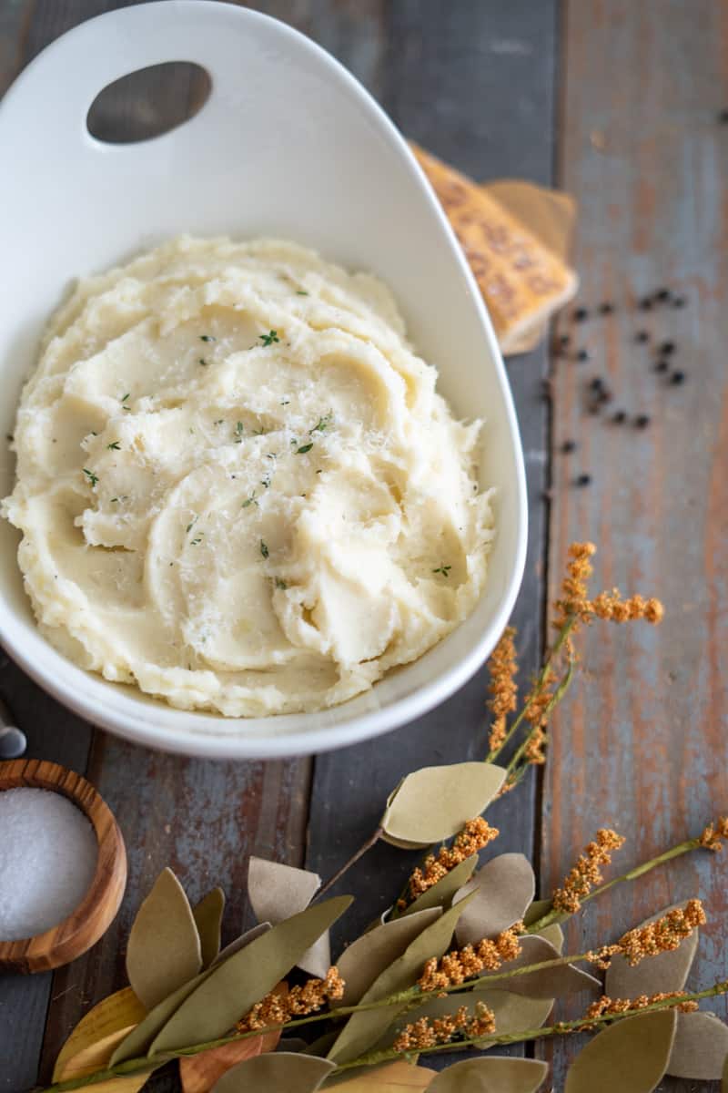 Mashed Potatoes in a bowl with parmesan and thyme