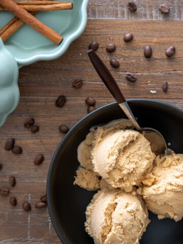 Pumpkin Spice Latte Ice Cream in a bowl next to coffee beans