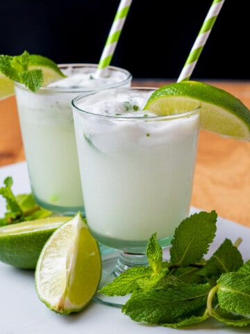 Coconut mojito with fresh mint and lime wedges