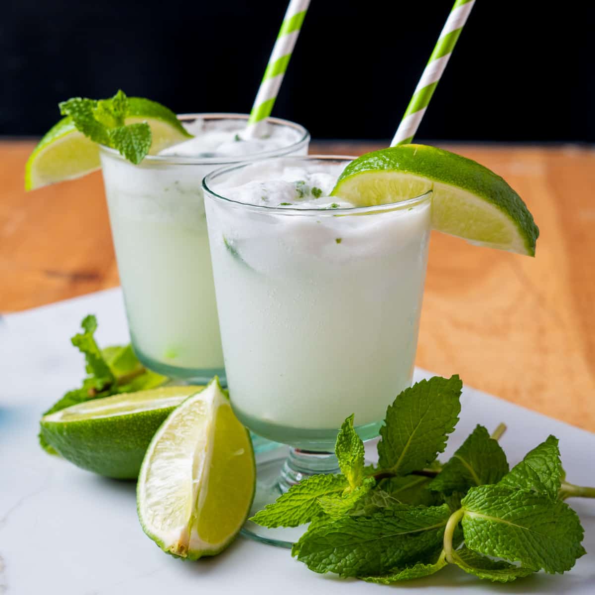 Coconut mojito with fresh mint and lime wedges