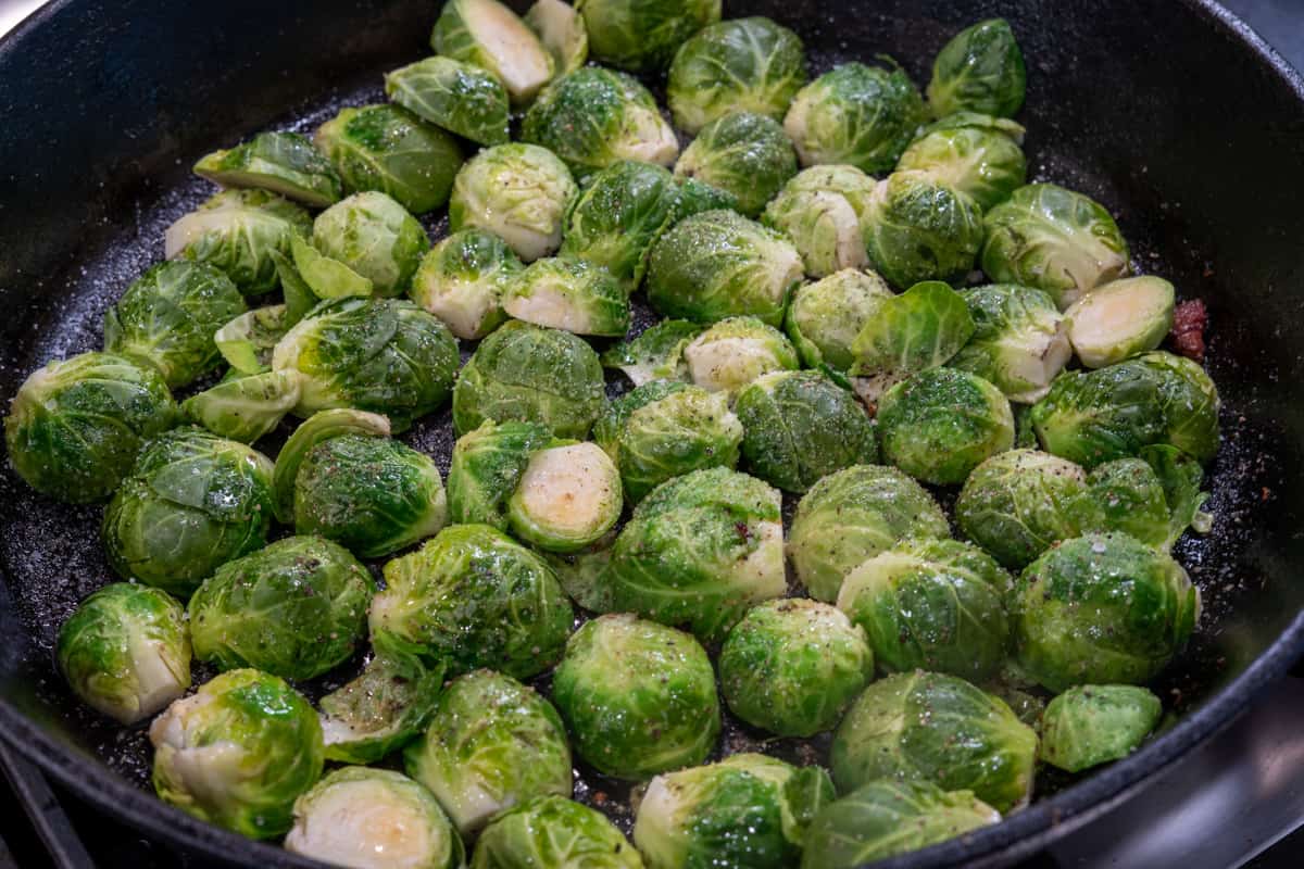 Brussel Sprouts searing in a a cast iron pan