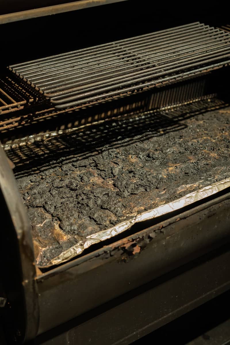 burn juices and drippings on the bottom of a pellet smoker