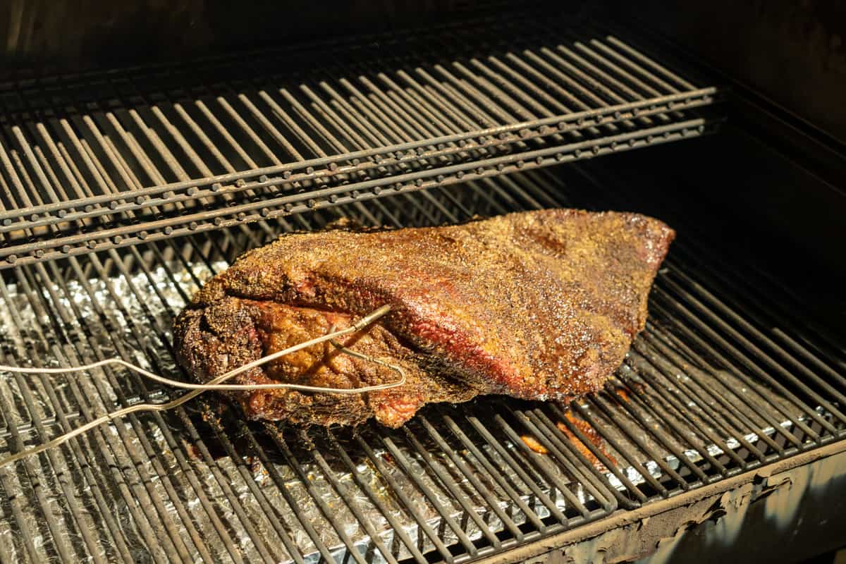 brisket on a pellet smoker with temperature probes inserted