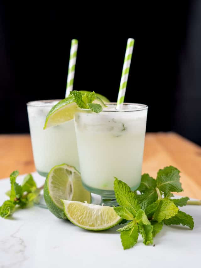 Coconut Mojito with fresh mint and lime wedges