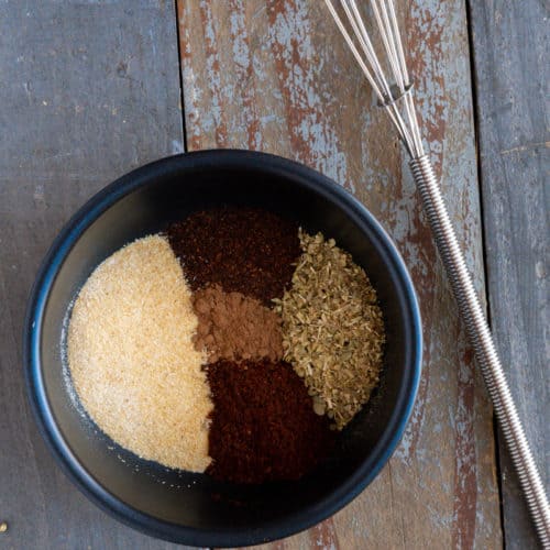 Spices measured out in a small black prep bowl