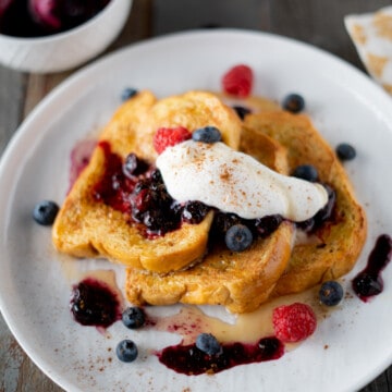 Brioche french toast with whipped cream and blueberry sauce