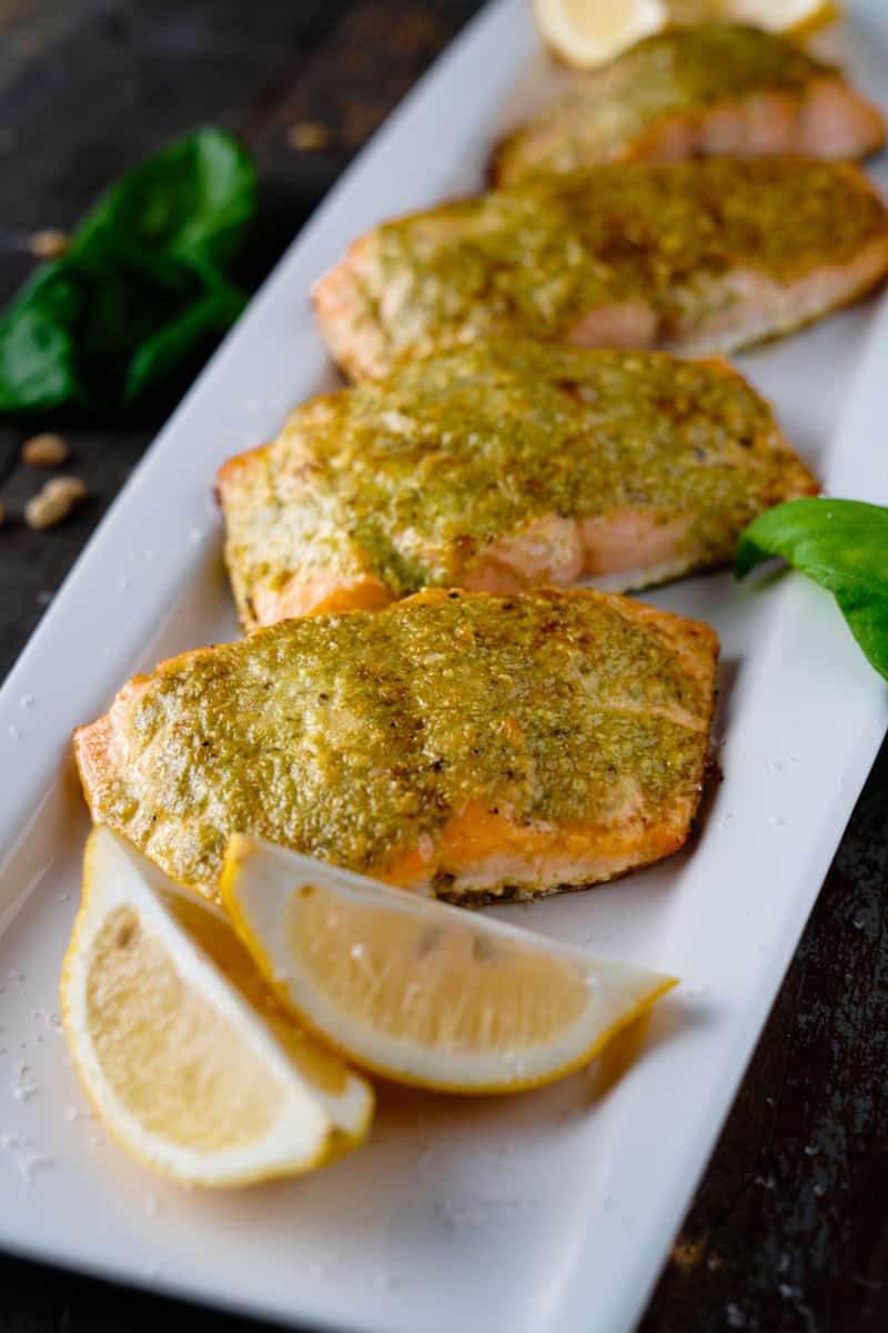 Pesto Salmon on a Platter with Lemon Wedges