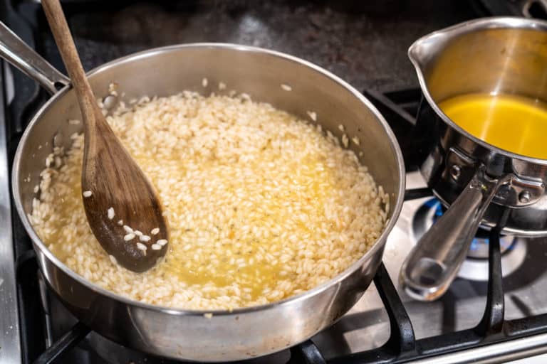 Risotto being mixed in a pot.