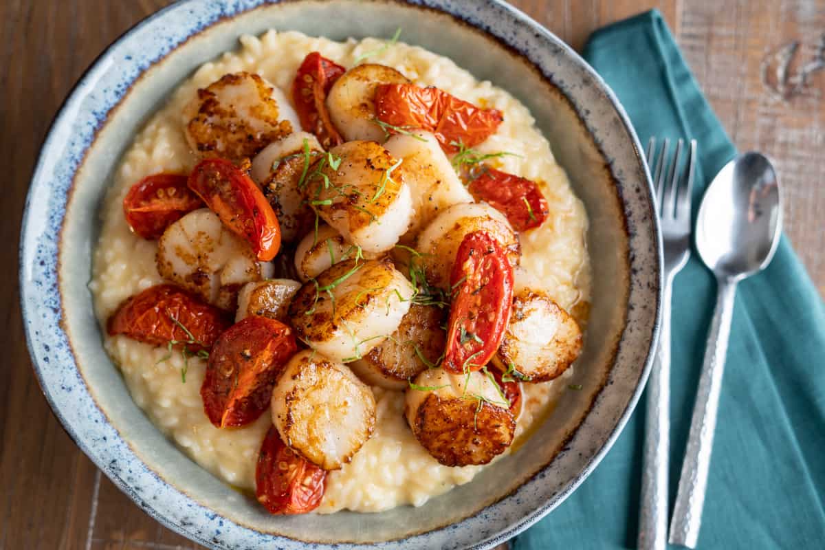 Seared Scallops on Truffle Risotto in a Bowl on a Table