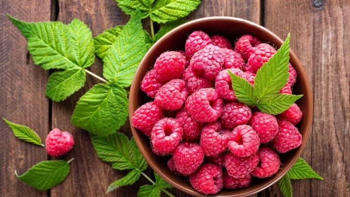 Bowl of Raspberries with leaves