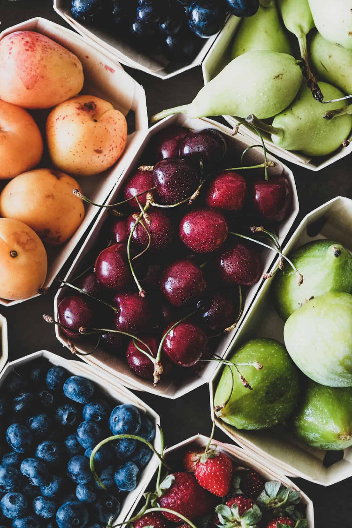 variety of fresh fruits in mini wood crates