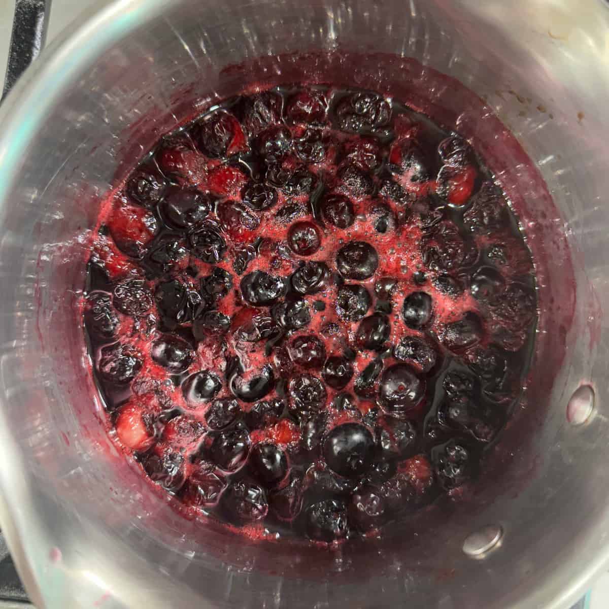 Blueberries simmering in a pot