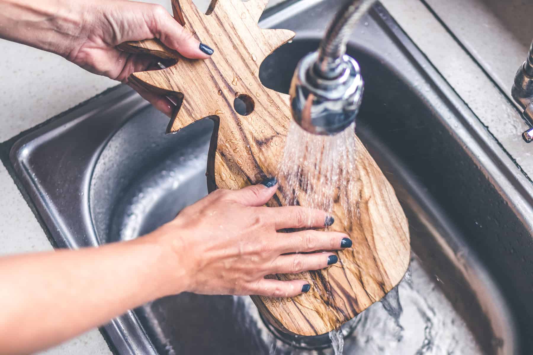 Washing a pineapple shaped wooden charcuterie board