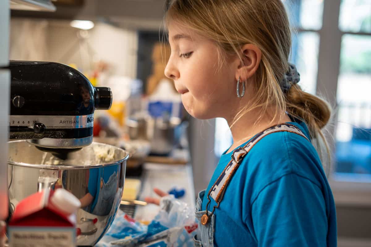 Girl looking into KitchenAid Mixer