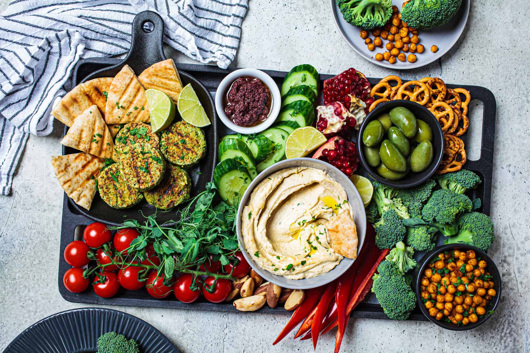 charcuterie board with vegetables, hummus, and fruit