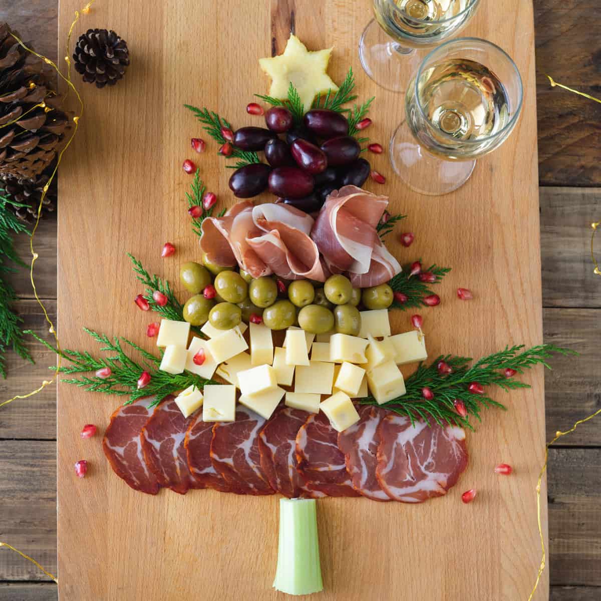 Christmas themed charcuterie board in the shape of a tree