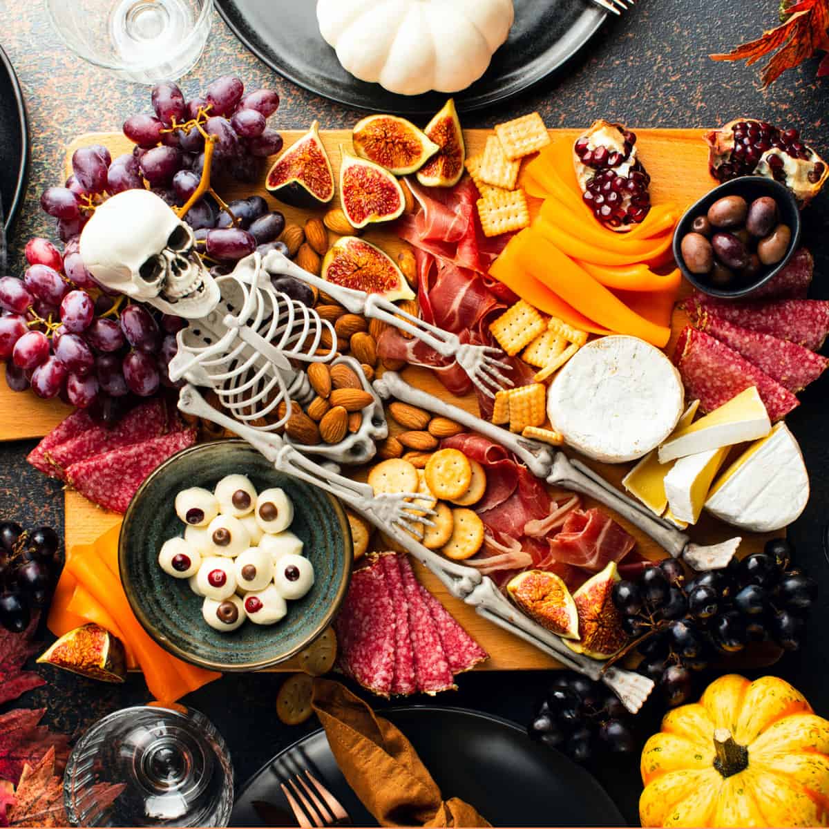 Halloween Themed Charcuterie Board with plastic skeleton