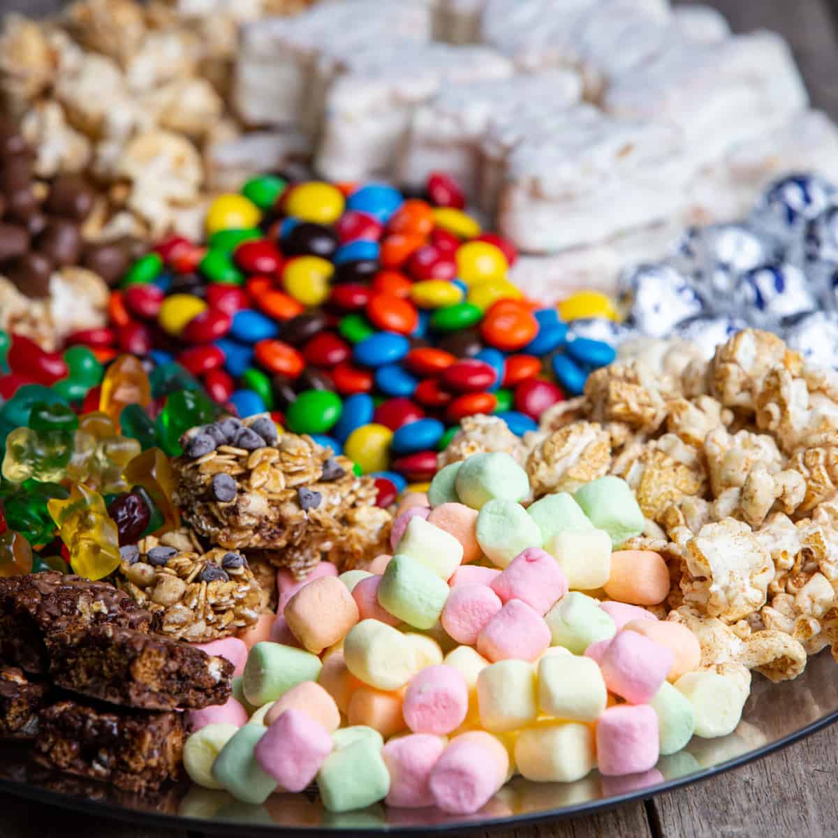 Snack Charcuterie Board with different candies, cookies, and marshmallows