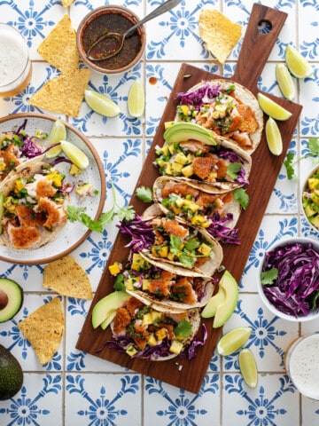 Rectangular charcuterie style board covered in tacos