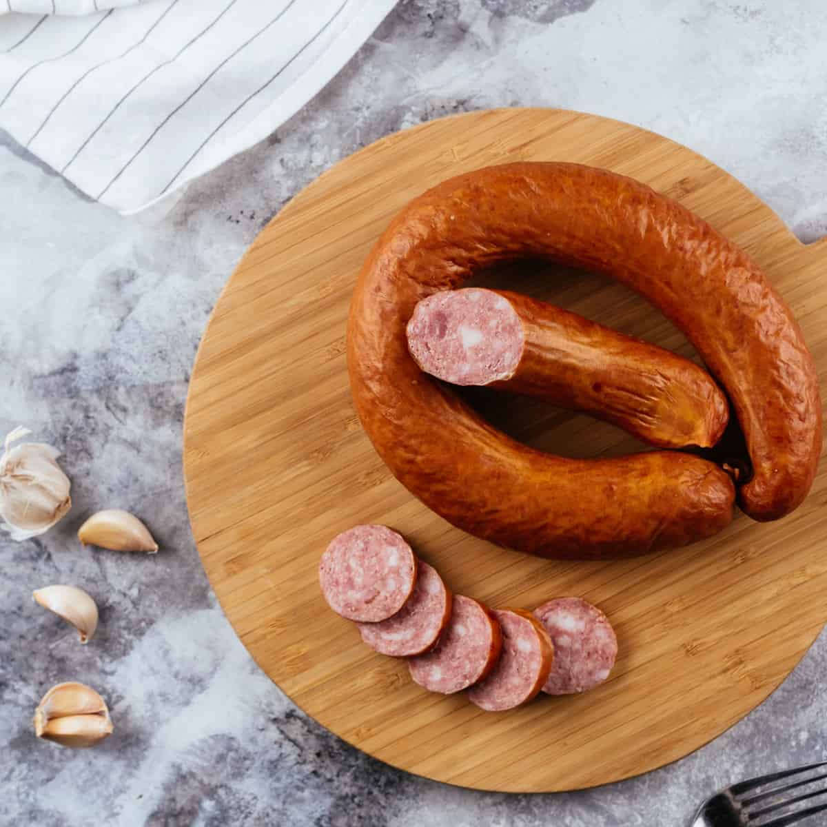 andouille sausage, sliced on a cutting board