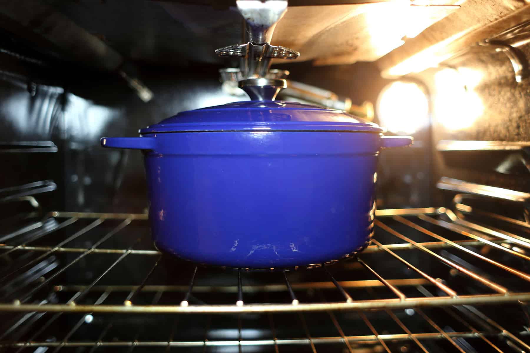 Blue dutch oven on an oven rack 