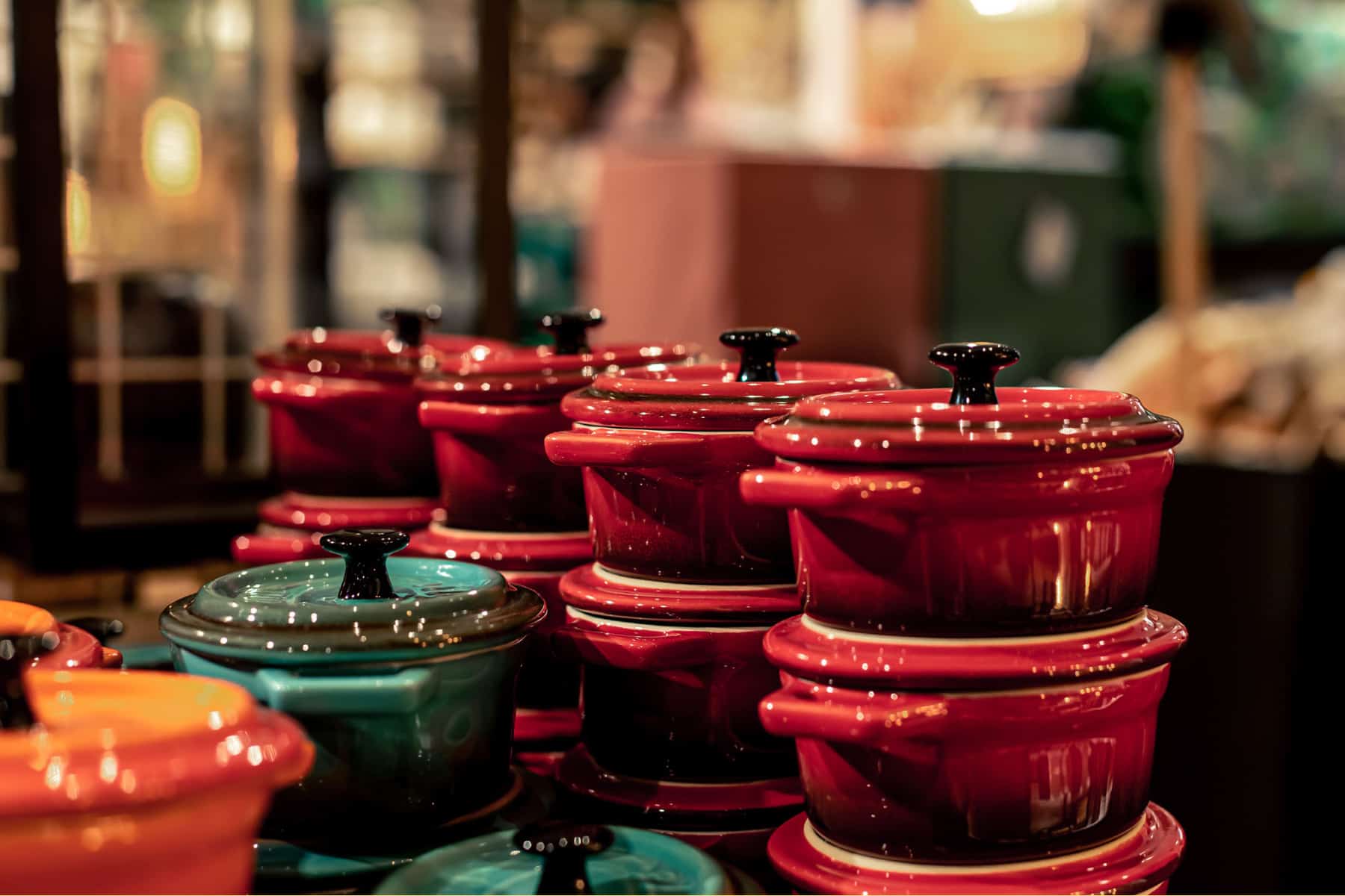 Stack of small dutch ovens for sale in a store