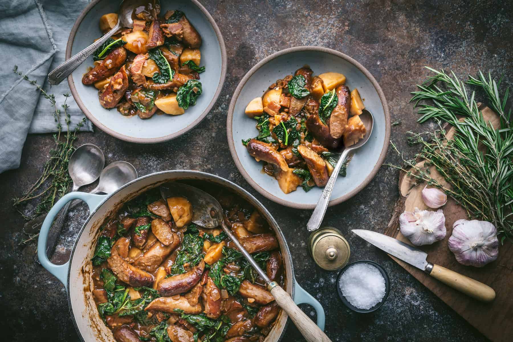 Stew braised in a dutch oven, with two bowls next to it. 