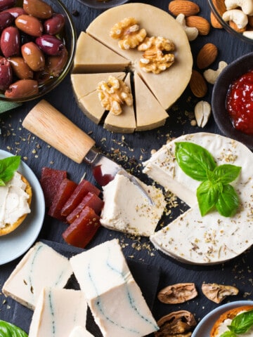 a charcuterie board with no pork, just cheeses, olives, nuts and crackers