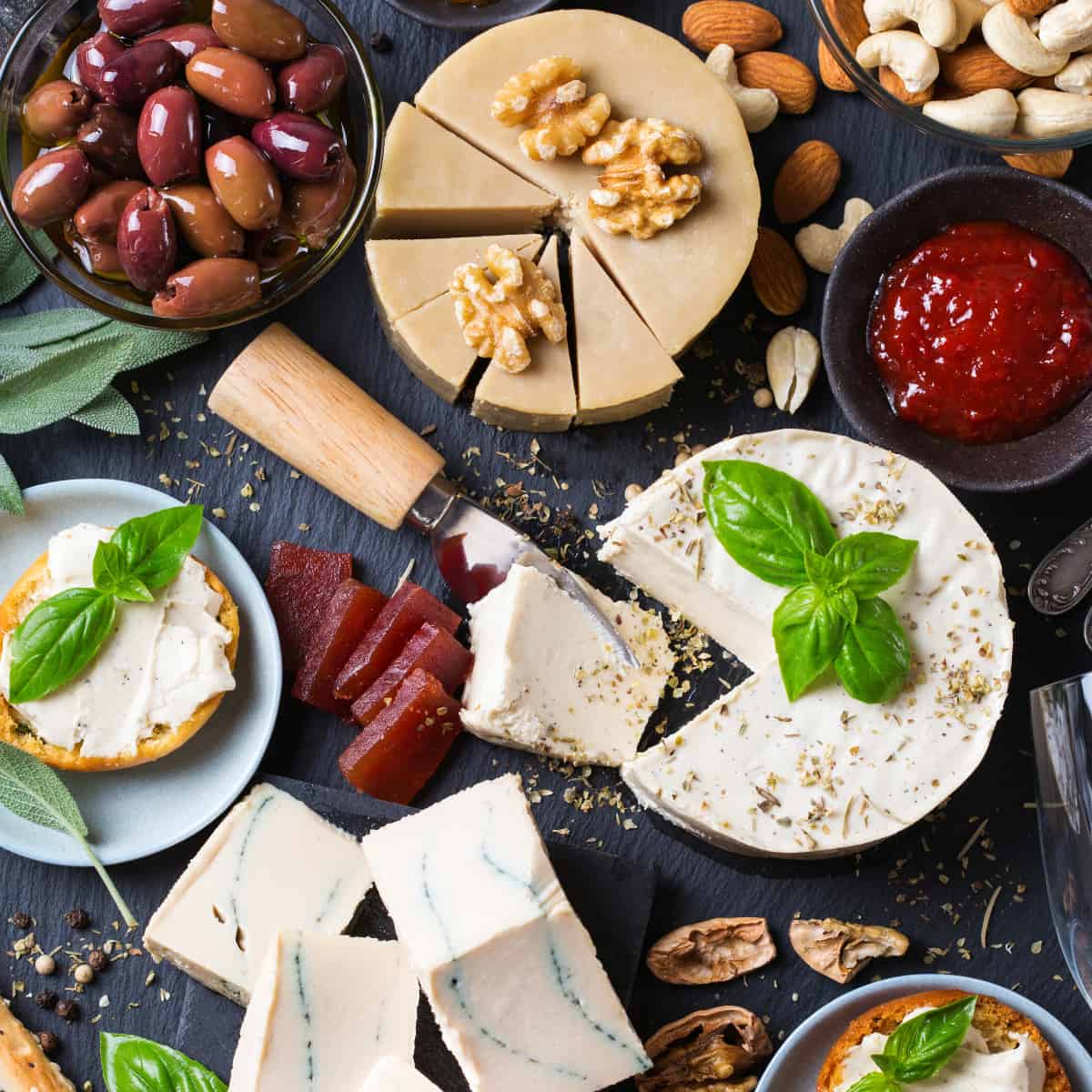 a charcuterie board with no pork, just cheeses, olives, nuts and crackers