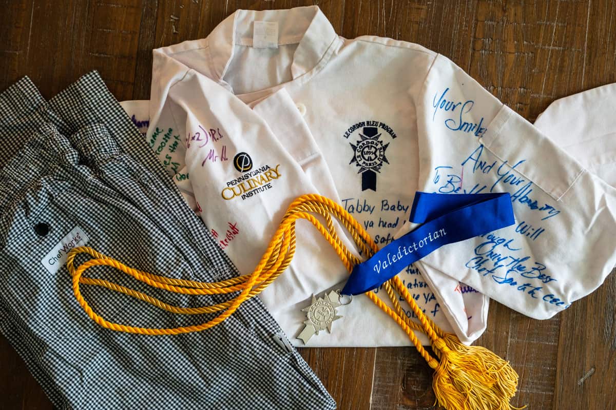 Tabetha's Chef jacket and pants with valedictorian metal and ribbons