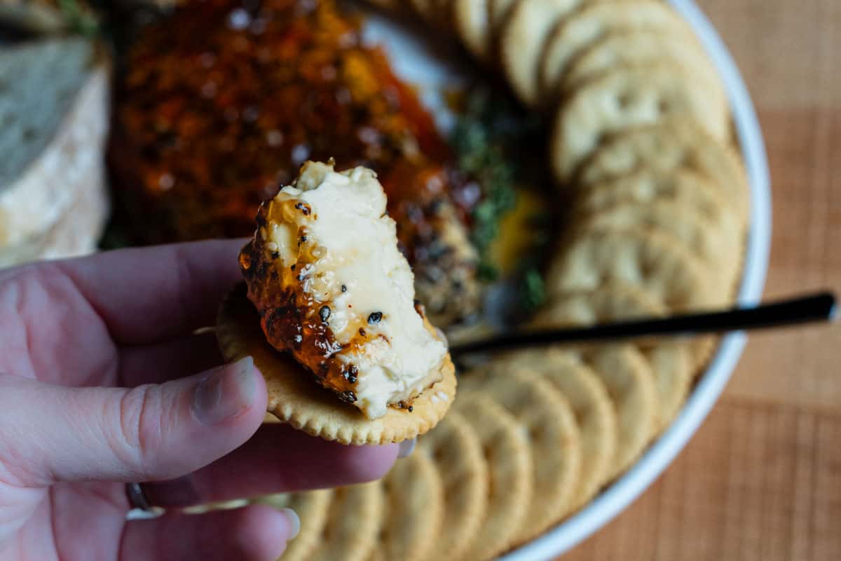 Finished smoked cream cheese topped with glossy red hot pepper jelly, ready to serve
